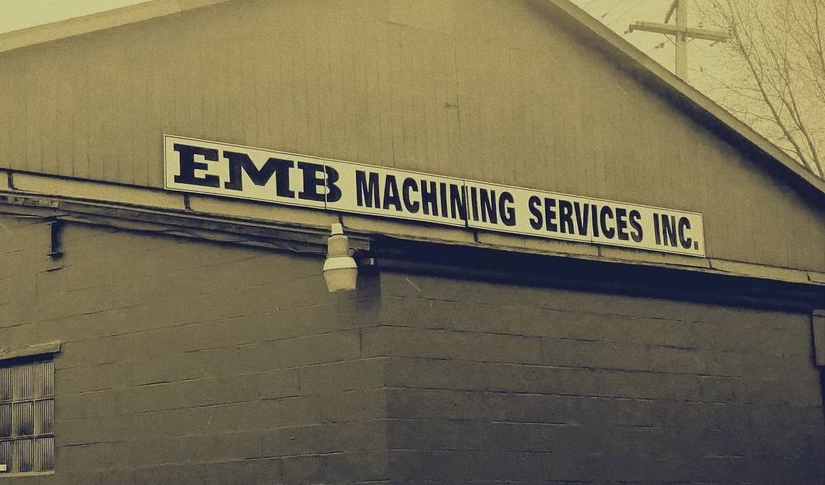 The EMB Machining Services, Inc. building in Whitney, Pennsylvania, with the company sign along the roofline.